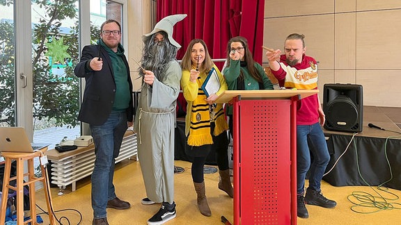 Menschen in Zauber-Kostümen in einer Aula