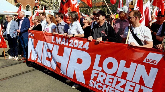 Menschen an einem Transparent zum 1. Mai. Mai-Kundgebung in Erfurt mit Oberbürgermeister Andreas Bausewein (Zweiter von links) und Innenminister Georg Maier (ganz links/ beide SPD)