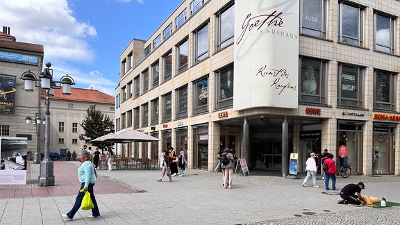 Menschen laufen am Goethekaufhaus in Weimar vorbei