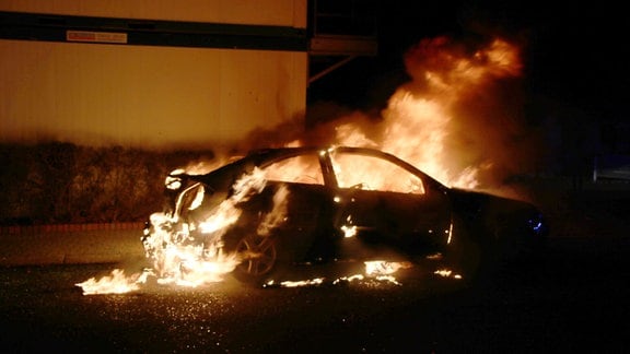 Ein Auto steht in Flammen.