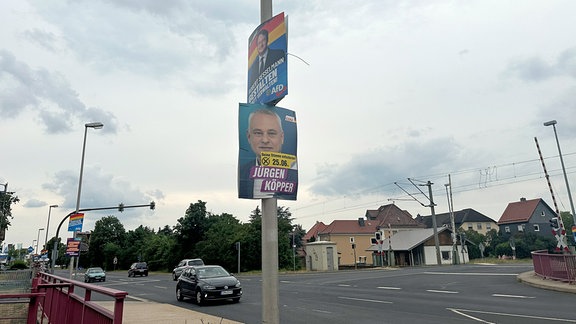 Zwei Wahlplakate hänen an einer Straßenlaterne.