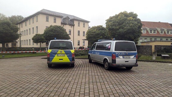 Polizeiwagen stehen nach einer Bombendrohung vor dem Gymnasium in Neudietendorf