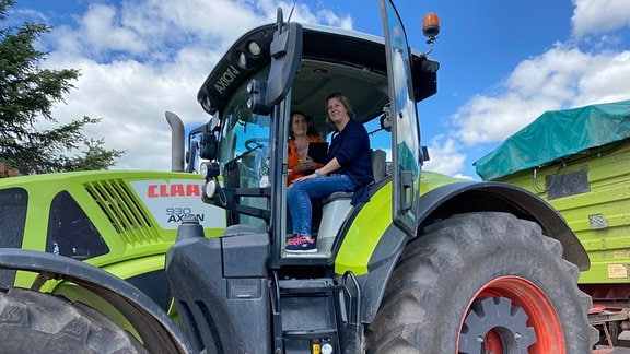 Landwirtin Simone Hartmann (blau) und Jurymitglied Anke Fritz (orange) im Traktor