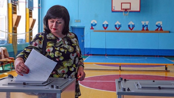VOLGOGRAD, RUSSIA - SEPTEMBER 8, 2019: A woman during the election of the Volgograd Region Governor and members of the Volgograd Region parliament at Polling Station 801.