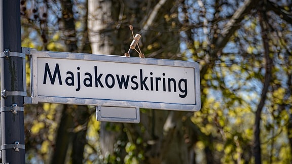 Korkmännchen auf einem Straßenschild 'Mayakovskiring' in Berlin Pankow