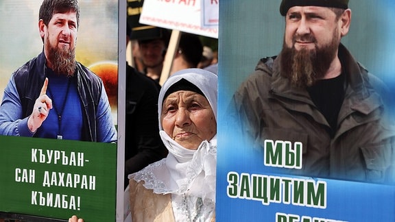 Eine Frau hält Porträts des tschetschenischen Oberhauptes Ramsan Kadyrow während einer Kundgebung in Grosny.