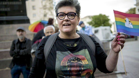 Aktivistin Elzbieta Podlesna schwenkt ein Fähnchen in den LGBTI-Regenbogenfarben und der Jungfrau Maria.