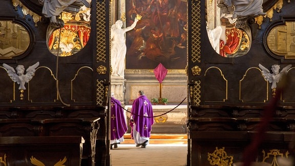 Zwei Priester feiern eine Messe in der leeren Basilika zu Krzeszów