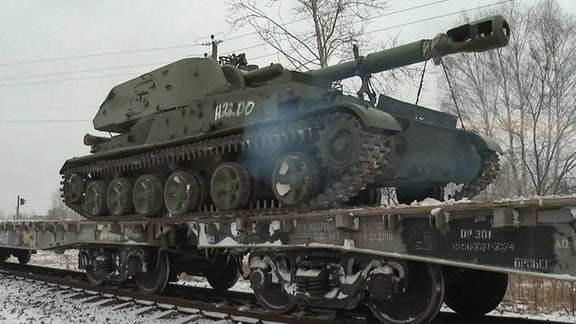 Ein Panzer auf einem Zug.