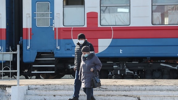 Zwei Menschen vor einem Zug
