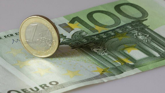 100 Euro-Note und 1 Euro-Münze