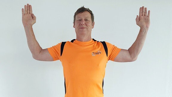 Mann in Sportkleidung zeigt die Fitnessübung - Schmetterling. 