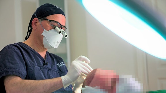 Im OP: Haarchirurg Reza Azar bei einer Haartransplantation in Berlin.