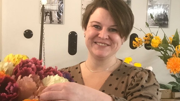 Lisa Schmidt Chefin der Deutschen Kunstblume Sebnitz mit Seidenblumenstrauß