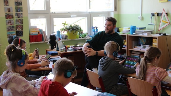 Andrei Vesa sitzt inmitten einer 4. Klasse an der Erfurter Grundschule "Wilhelm Busch". Vesa ist eigentlich Musiker und kam erst über Umwege zum Lehrerberuf: „Grundschule ist genau mein Ding!“