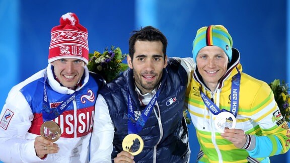 Bild zeigt Evgeniy Garanichev (RUS), Martin Fourcade (FRA) und Erik Lesser (GER). 
