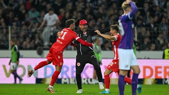 Trainer Claus-Dieter Pele Wollitz (Cottbus) jubelt nach dem Tor zum 2:3 mit Yannik Möker Moeker (Cottbus) und Axel Borgmann (Cottbus).