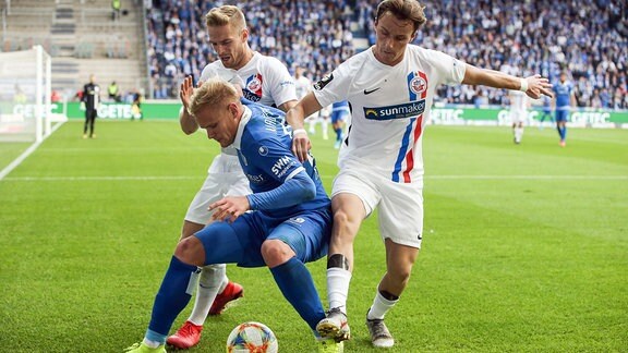 Sören Bertram (1. FC Magdeburg) gegen Mirnes Pepic re. und Nils Butzen (FC Hansa Rostock).