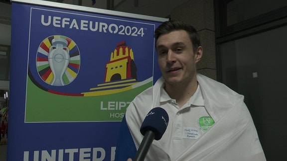 Handball-Spieler im Interview mit Tschechienfahne um die Schultern gelegt