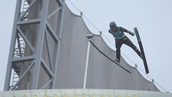 Eine Person beim Skisprung.