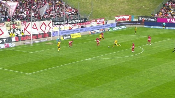 Spieler von Dynamo Dresden spielt den Ball ins Tor.
