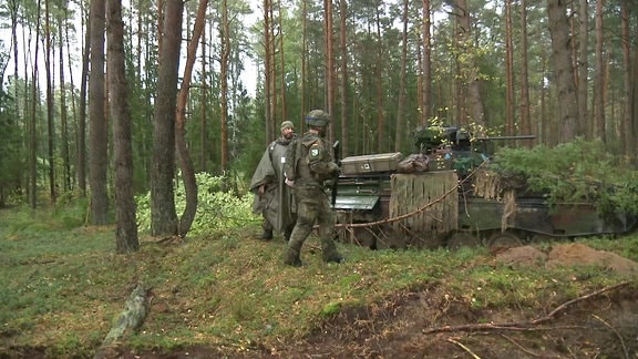 Soldaten neben einem Panzer