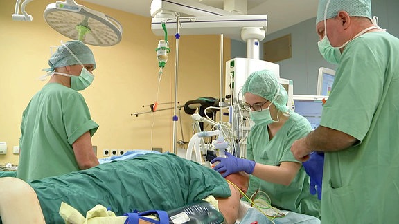 Eine OP-Situation: Drei Ärzte operieren einen Patienten