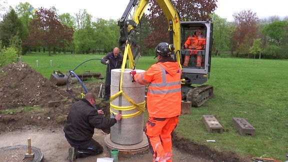 Bauarbeiter montieren Brunnensäule