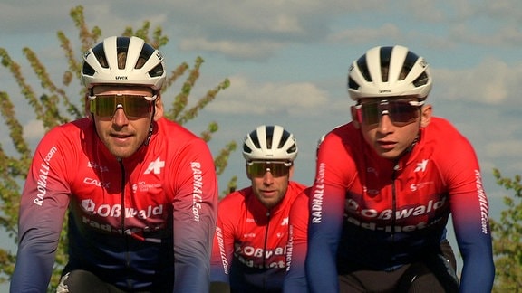 Drei Radfahrer mit Helm und Sonnenbrillen 