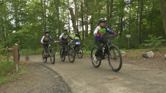 Radfahrer auf einem Waldweg.