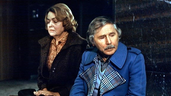 Die Ehefrau von Paul Karuschke und Otto Karuschke, Pauls Bruder, sitzt trauernd auf einer Bank.
