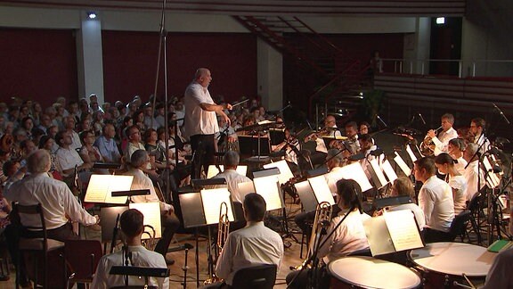 Ein Dirigent mit einem Orchester
