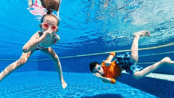 Kinder schwimmen unter Wasser