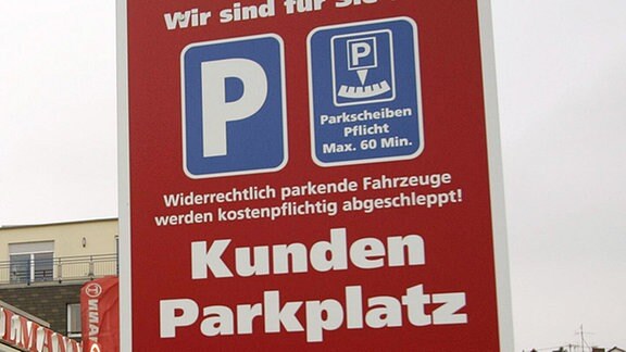 Hinweisschild führt zum Kundenparkplatz.