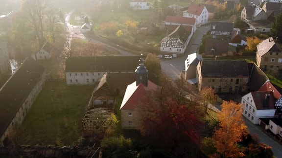 Luftaufnahme des OrtesDobitschen. Im Vordergrund eine Kirche und weitere Gebäude.