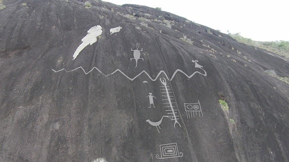 Auf dieser undatierten, vom Forscher Dr. Philipp Riris zur Verfügung gestellten Darstellung sind an einem Felsen Petroglyphen und ihre entsprechende Größe im Verhältnis zum Maßstab zu erkennen. 