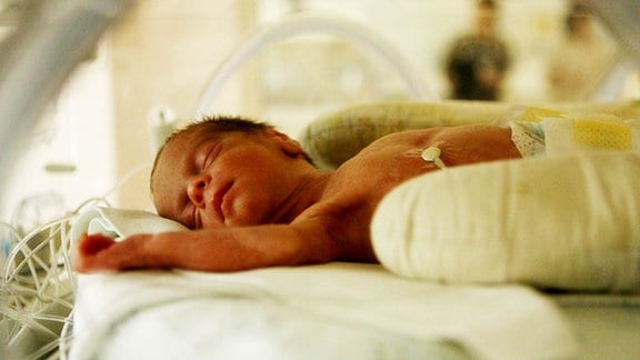Ein neugeborenes Baby im Brutkasten.