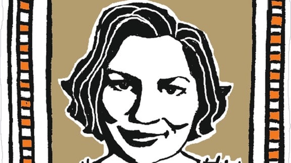 Porträt einer Frau mit halblangen, wallenden und gescheitelten dunklen Haaren mit einem freundlichen Lächeln in einem schwarzen Pulli mit weißen Fransen.
