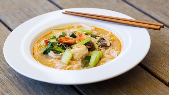 Schale mit traditioneller thailändischer Tom-Yam-Suppe mit Gemüse und Garnelen in einer würzigen aromatischen Brühe