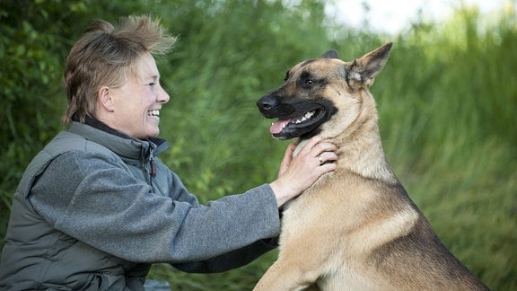 Frau streichelt ihren Hund