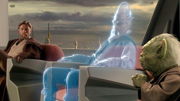 Filmszene aus Star Wars, ein Jedi bei einer Versammlung erscheint als Hologramm