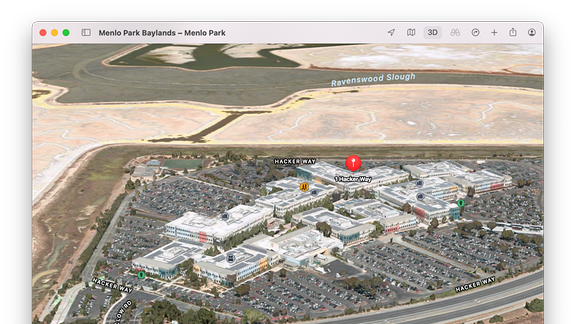 Kartenanwendung Apple Maps mit 3D-Flyerover-Darstellung des 1 Hacker Way in Menlo Park und Zweckbauten mit großem Parkplatz, die der Firmensitz von Meta bzw. Facebook sind.