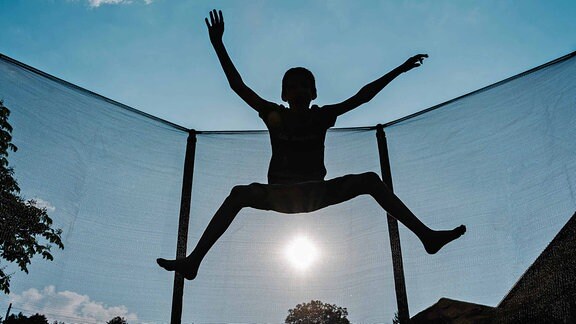 Ein Kind springt auf einem Trampolin