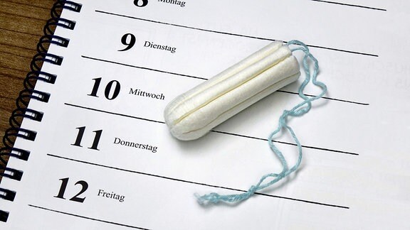 Nahaufnahme Kalender mit Tagen und Wochentagnamen untereinander, darauf ein Tampon.