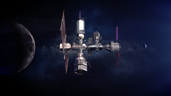 Eine Illustration zeigt, wie die Raumstation Gateway im All aussehen wird, im Hintergrund ist die Milchstraße zu sehen.
