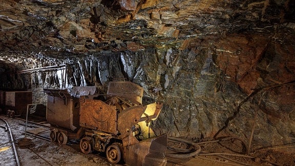 Eine Lore mit Abbruch steht untertage im Besucherbergwerk Ehrenfriedersdorf