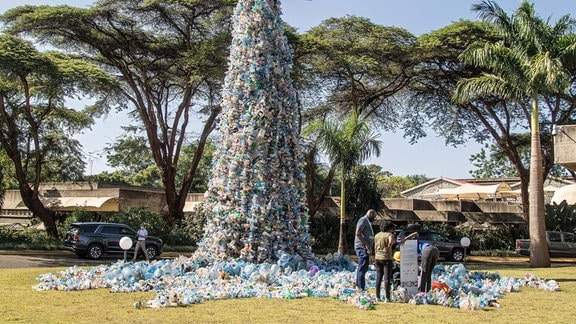 Menschen stehen neben einer Skulptur zum Thema Plastik Müll des kanadischen Künstlers und Aktivisten Benjamin von Wong.