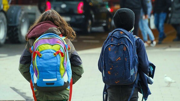 Zwei Schüler mit Ranzen auf dem Schulweg