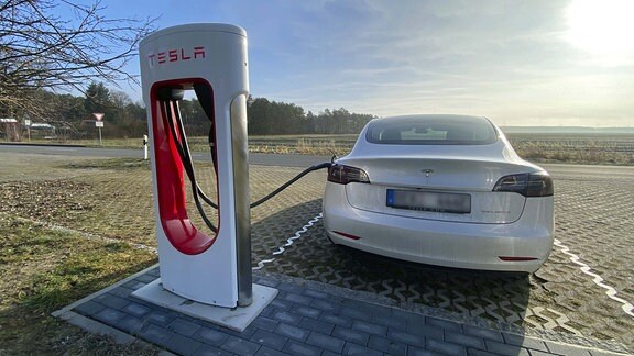 Ein Tesla Model 3 steht zum Aufladen an einem Tesla Supercharger in Bersteland.